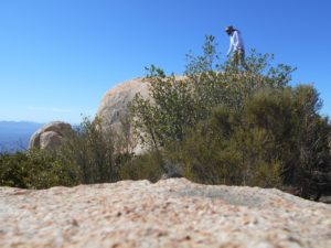 Me, climbing around on some boulders on the summit for better views!