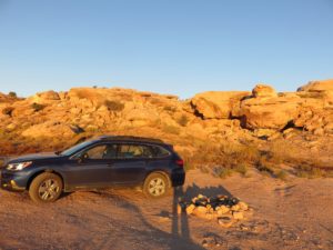 Car camped out in front of boulders