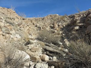 A rock-filled wash on the side of the mountain